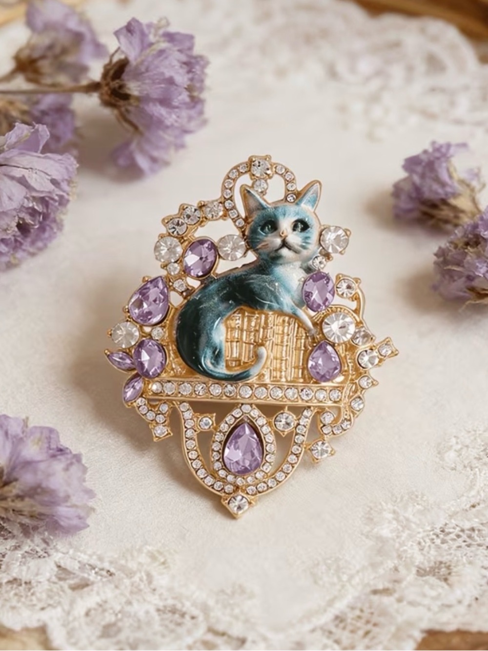 cat brooch featuring blue enamel feline surrounded purple & clear rhinestones.